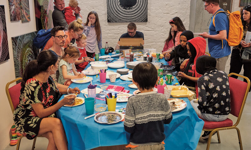 Families decorating plates at the Good Food; Our Food exhibition 